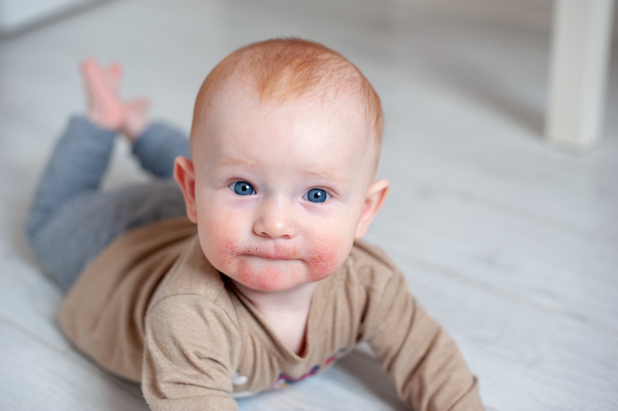 a baby sitting on a bed